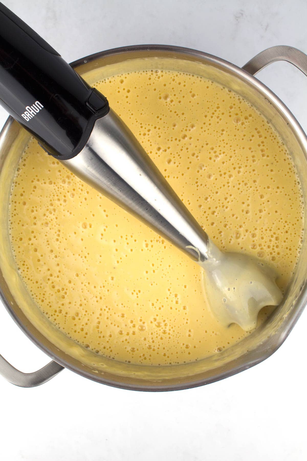 Immersion blender in ultra-creamy mac and cheese sauce.
