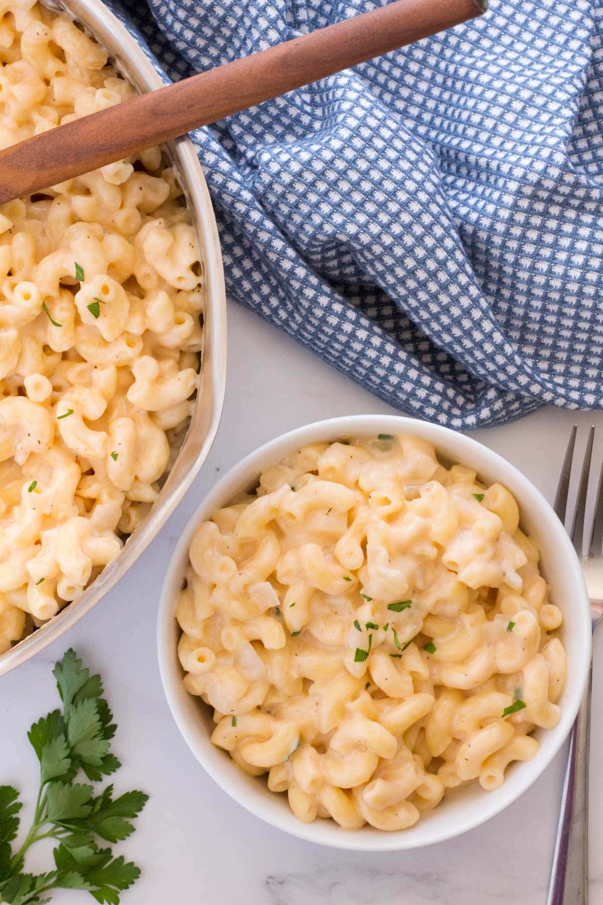 Quick mac and cheese recipe in a serving bowl with pan next to it.