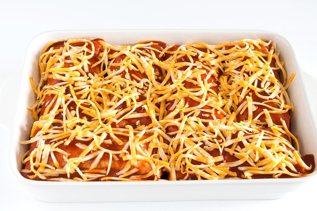 Rolled up shredded beef burritos smothered in enchilada sauce and shredded cheese.
