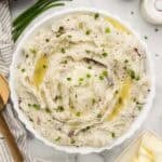 Bowl of mashed potatoes with butter on top.
