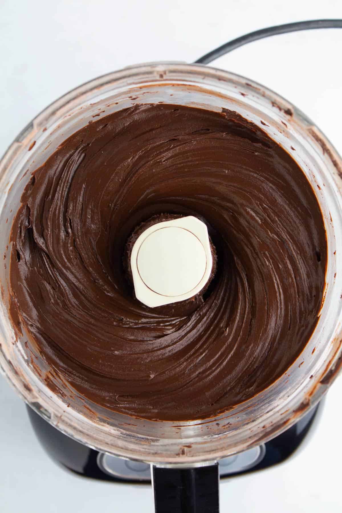 Smooth chocolate frosting combined in a food processor.