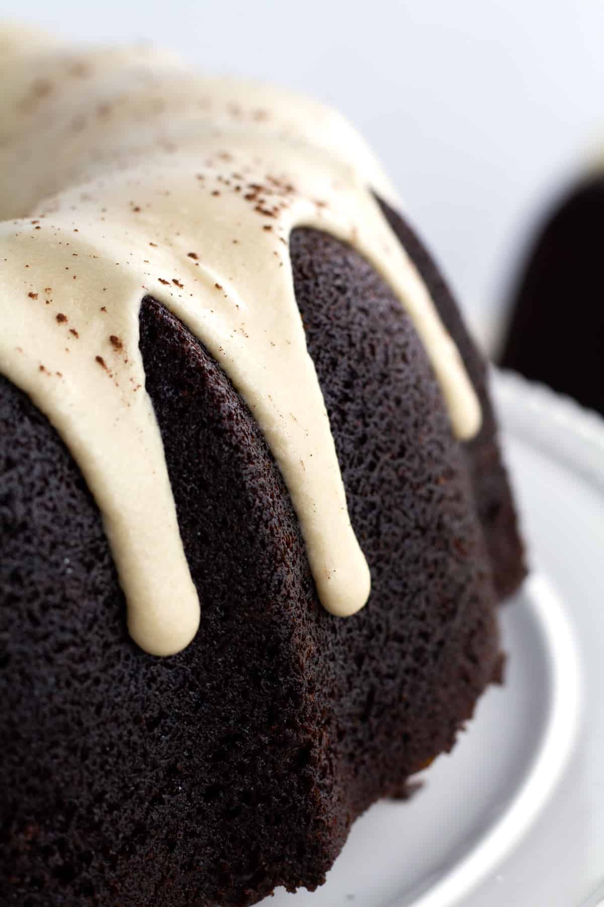 Close up of chocolate bundt cake with Kahlua glaze drips falling down the side.