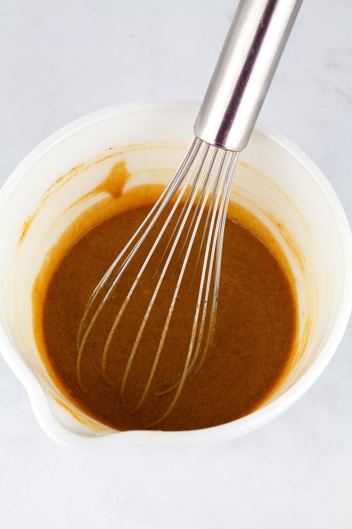 Cinnamon sugar sauce made with brown sugar and butterscotch pudding mixed in a bowl.