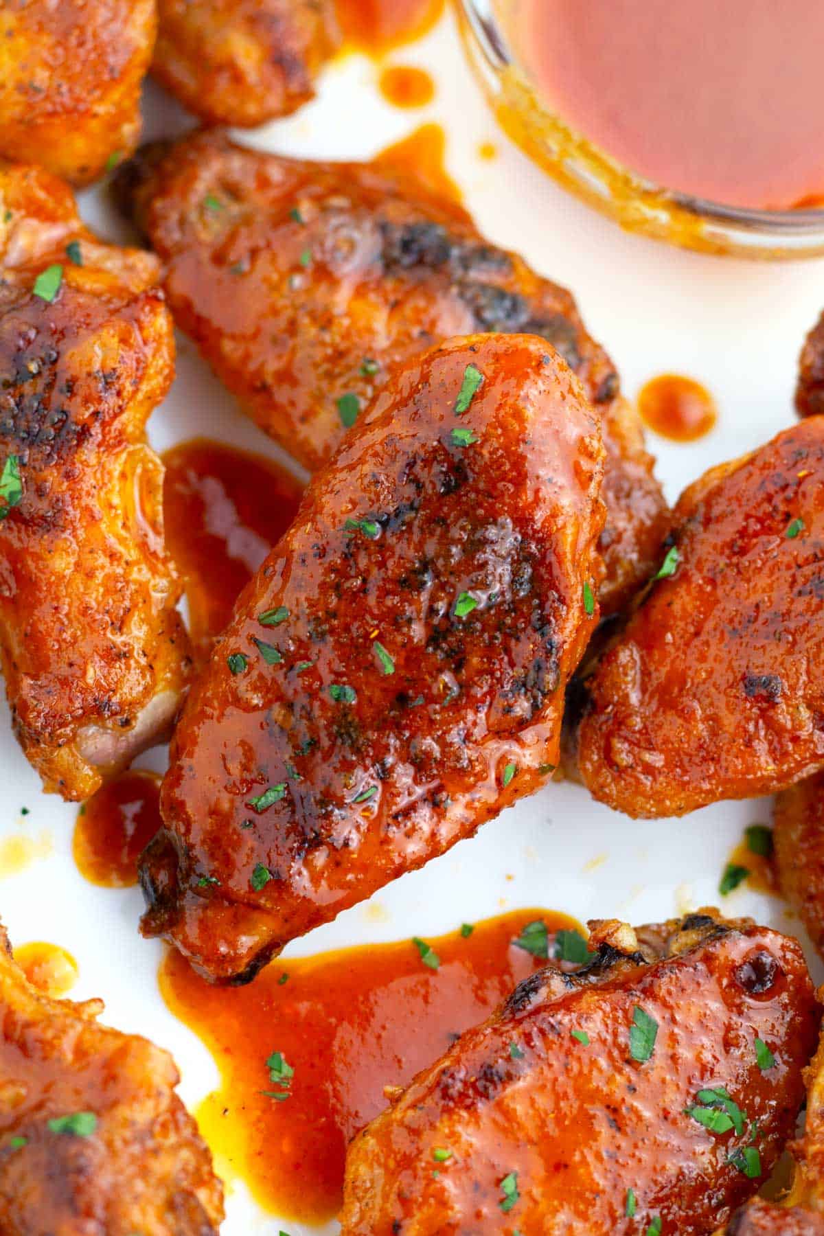 Crispy oven-baked buffalo chicken wings on platter.