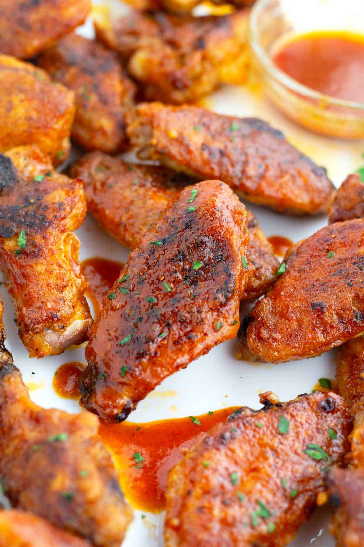 Crispy skin on chicken wing coated in spicy buffalo sauce.
