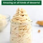 Peanut butter whipped cream piped into a glass jar with peanut butter chips in the foreground and text overlay on the top of the image.
