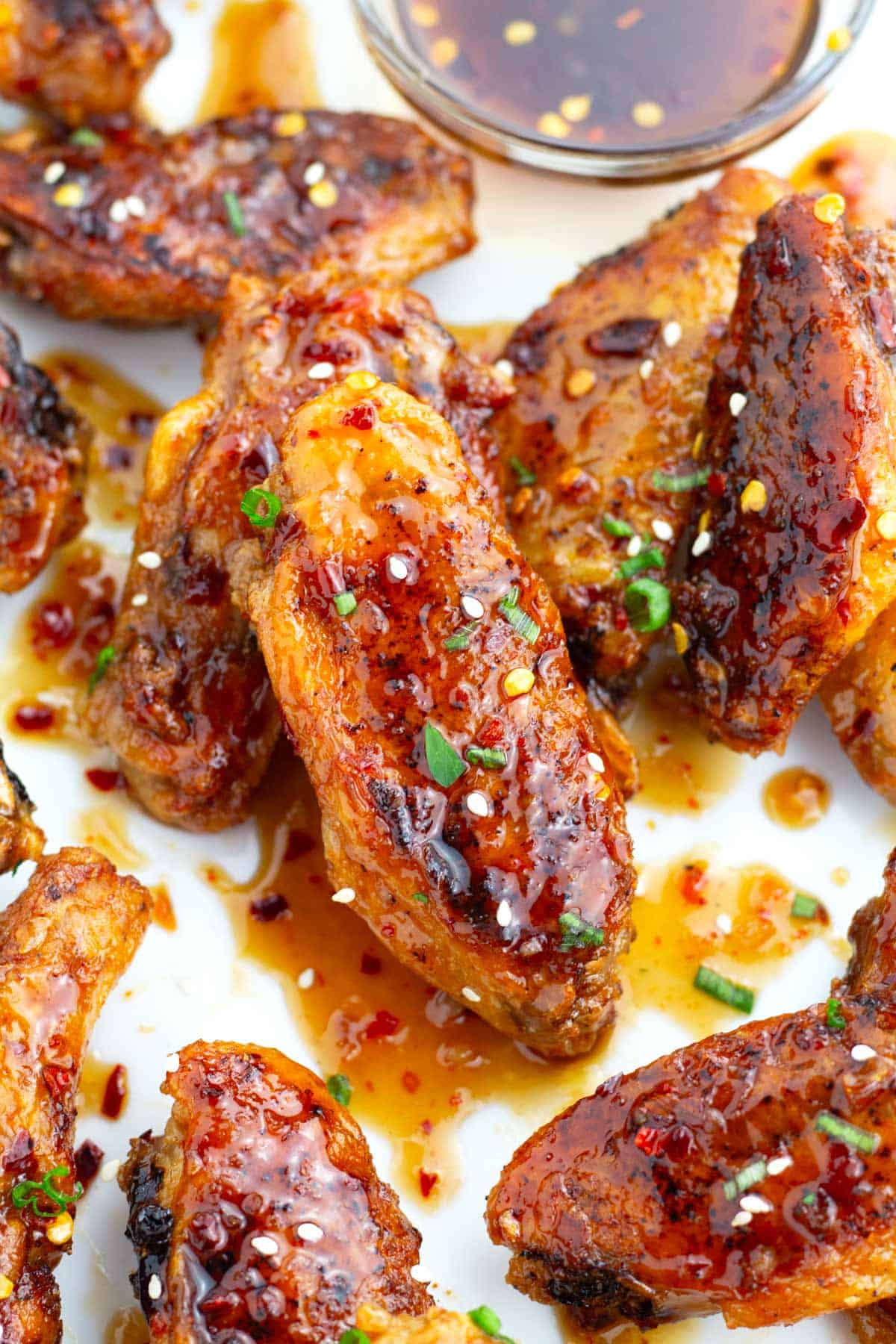 Sweet chili glaze covering chicken wings.