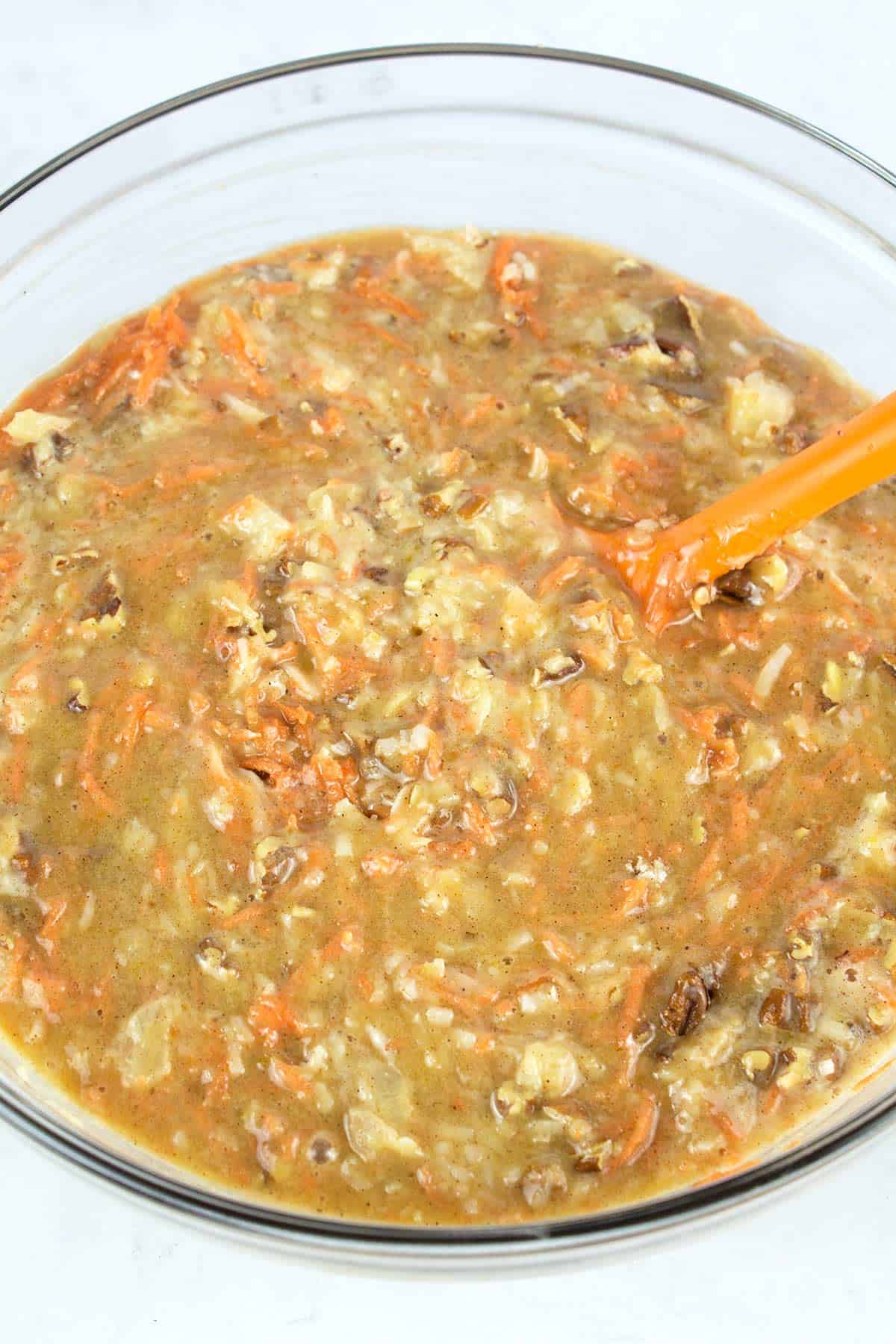 Carrots, coconut, pineapple, and pecans mixed into carrot cake batter.