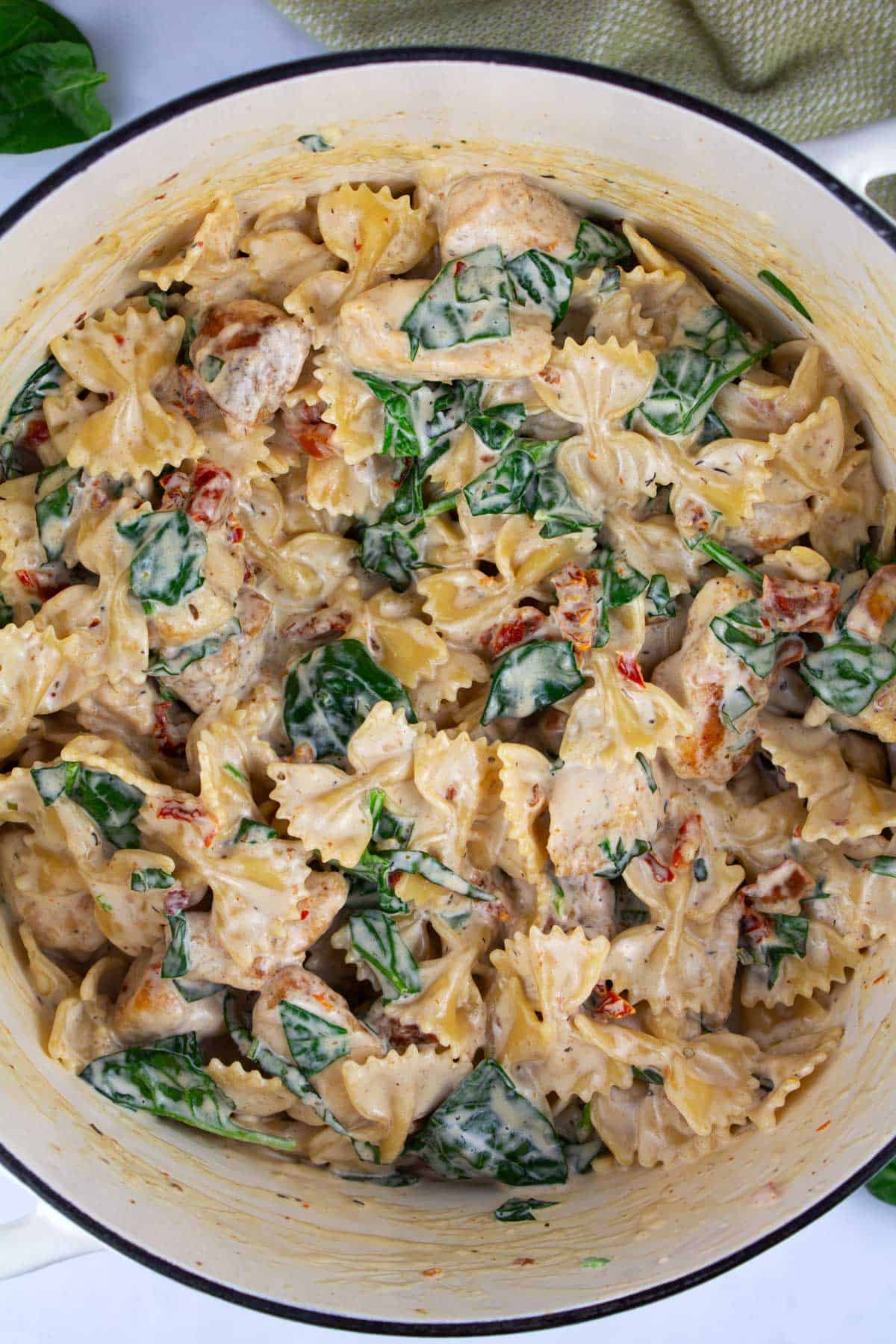 Finished recipe of creamy marry me chicken pasta stirred together in a large dutch oven.
