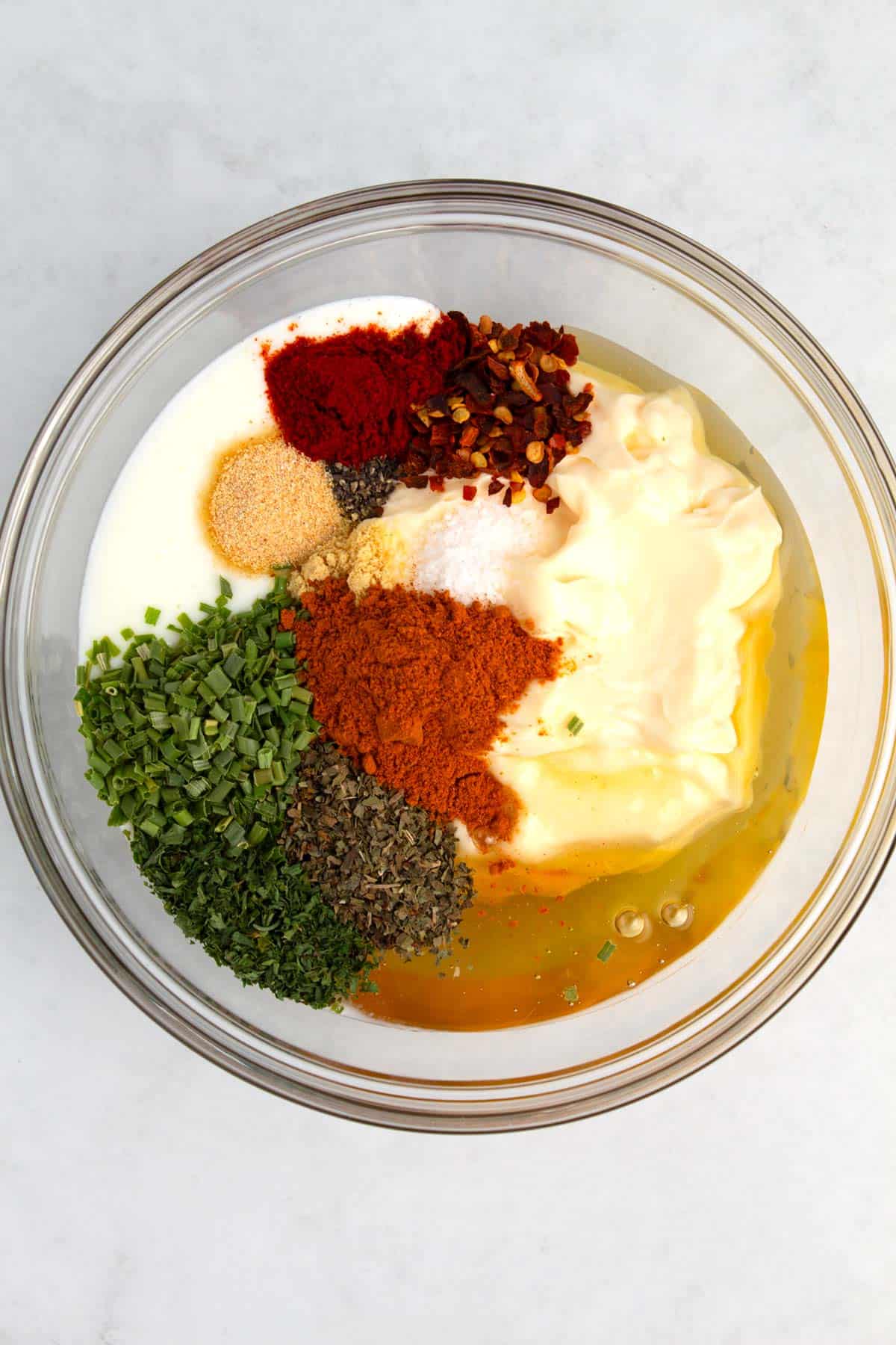 Ingredients for creamy hot honey dressing in bowl before mixing together.