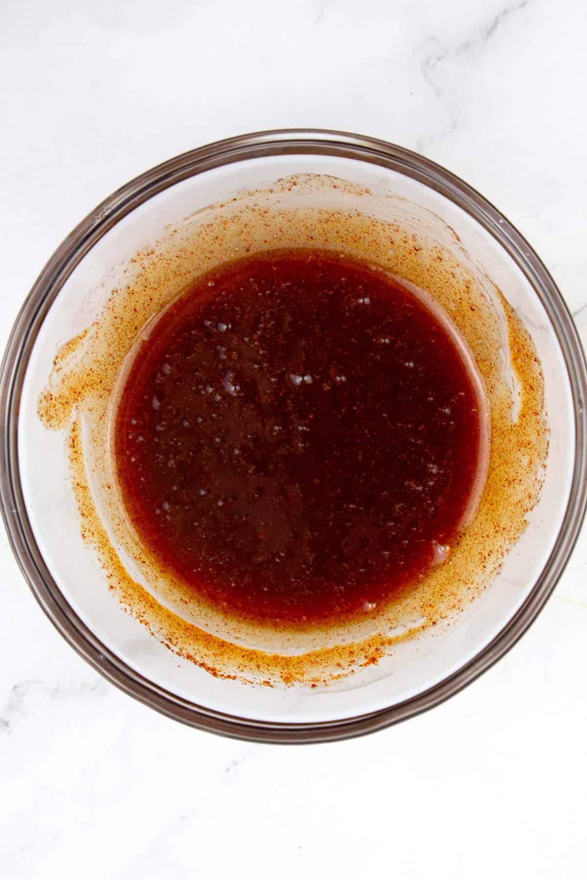 Bowl of hot honey sauce prepared before drizzling over popcorn.