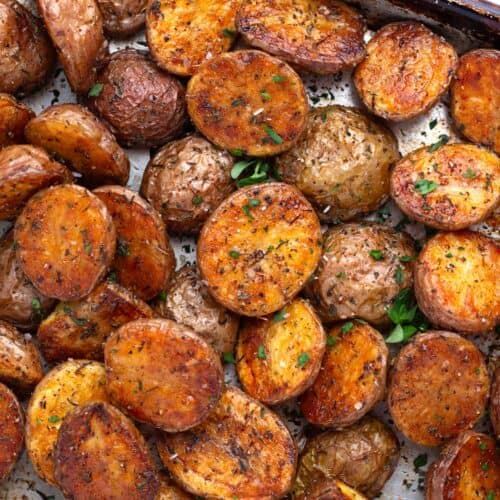 Deeply golden brown baby red and yukon gold potato halves tossed with olive oil and seasonings.