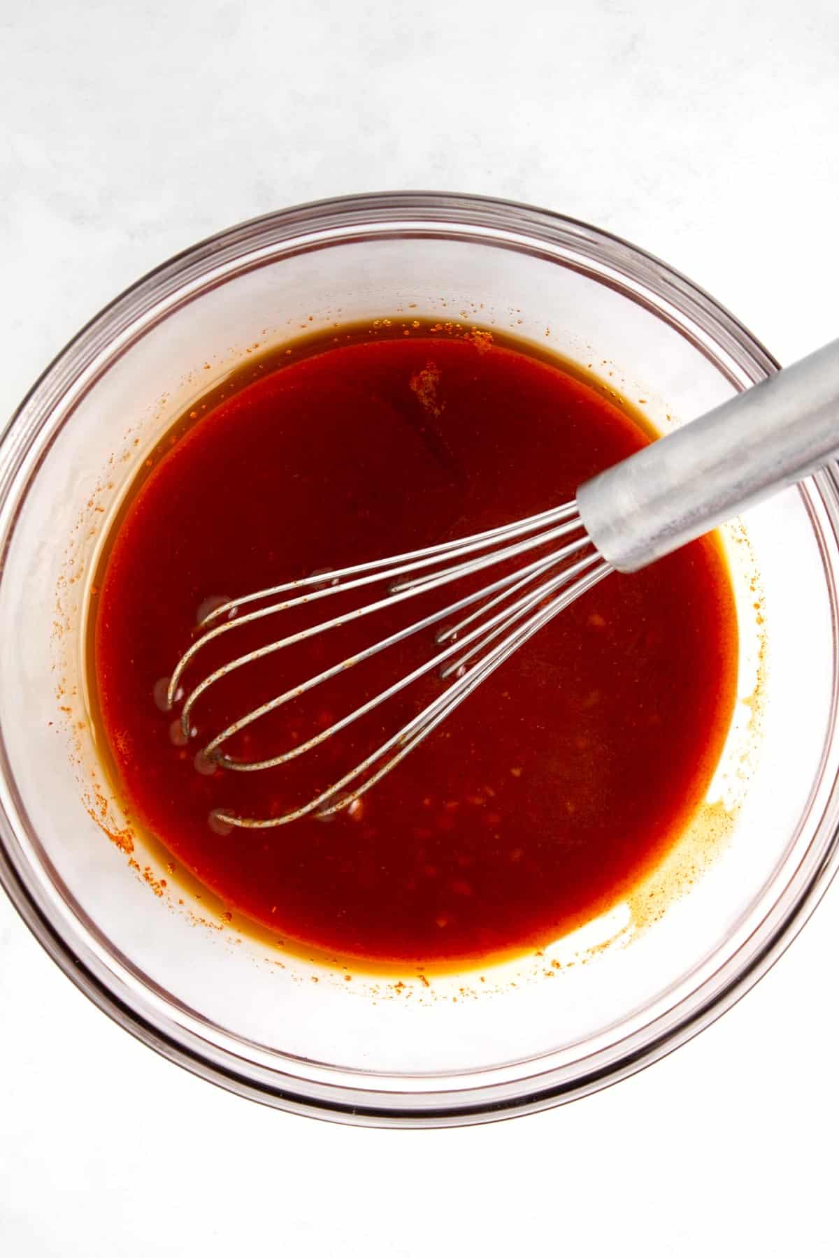 Whisking together the marinade ingredients in small glass bowl.