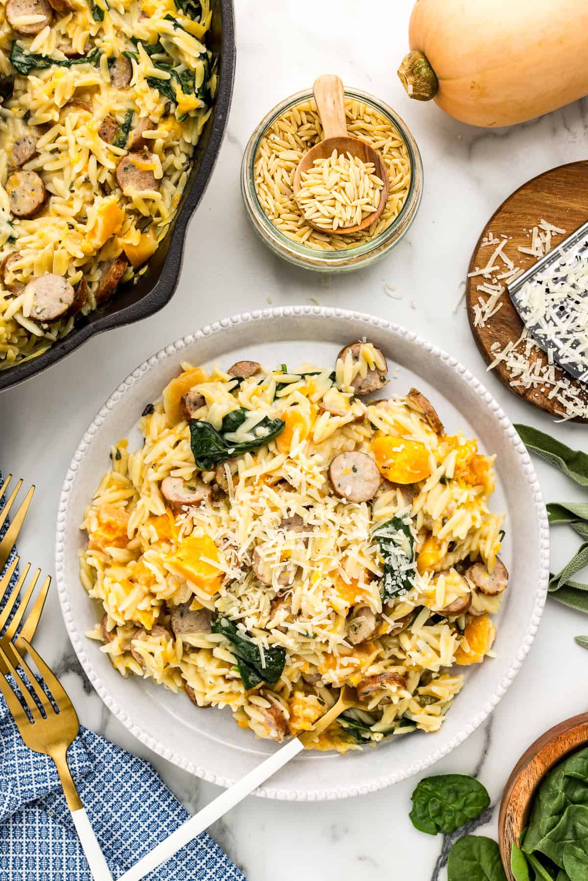 Serving plates with one pan orzo pasta.