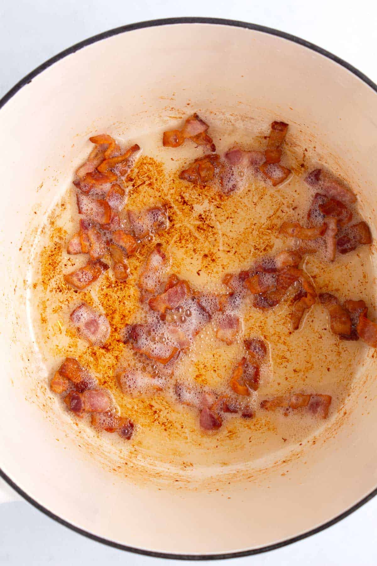 Diced bacon cooked in dutch oven.