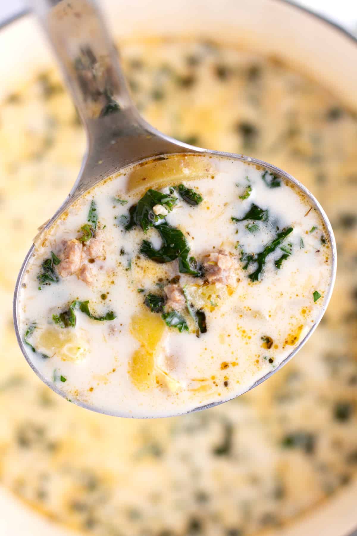 Ladle serving up a serving Tuscan Potato Soup also known as Zuppa Toscana.