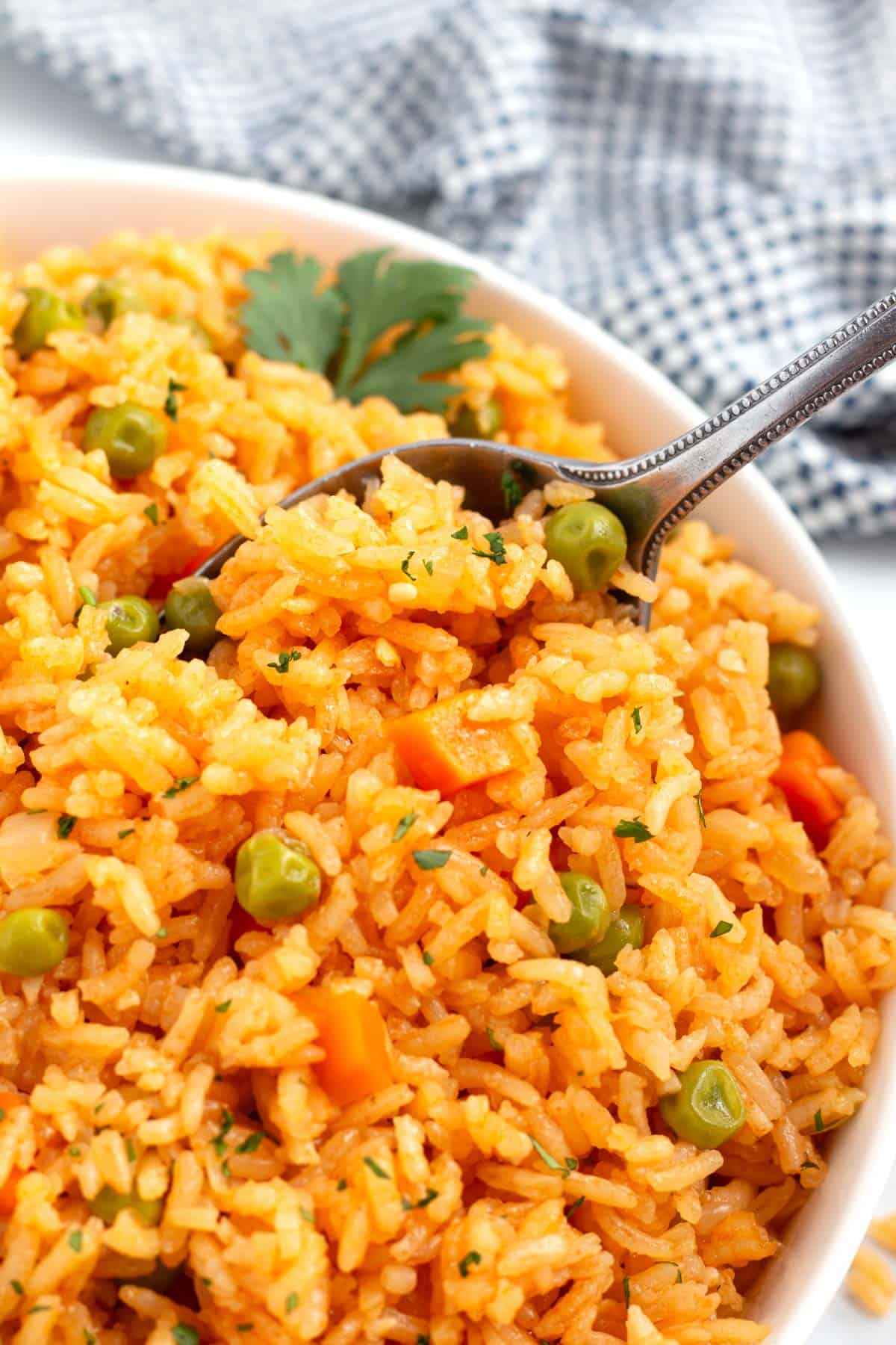 Scooping Mexican Spanish rice to serve with tacos, burritos, or enchiladas.