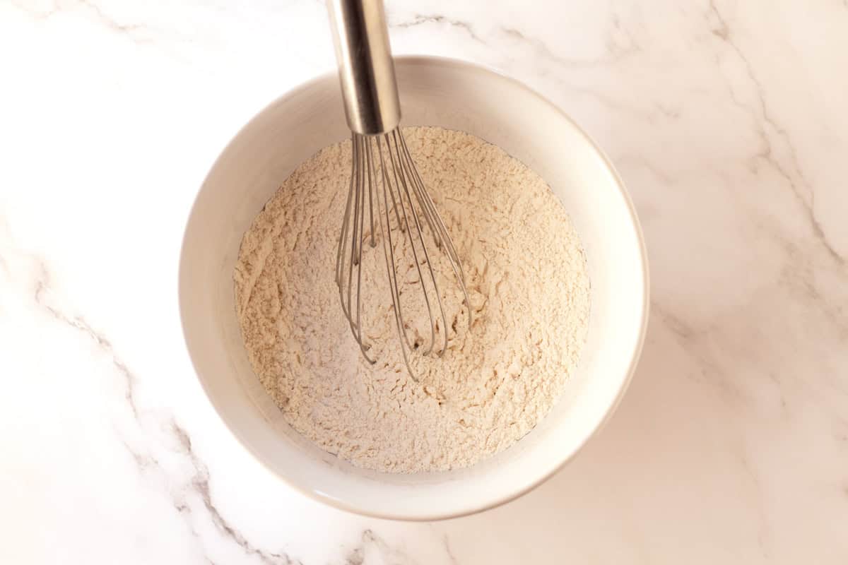 Whisking flour to lighten it before adding in liquids.