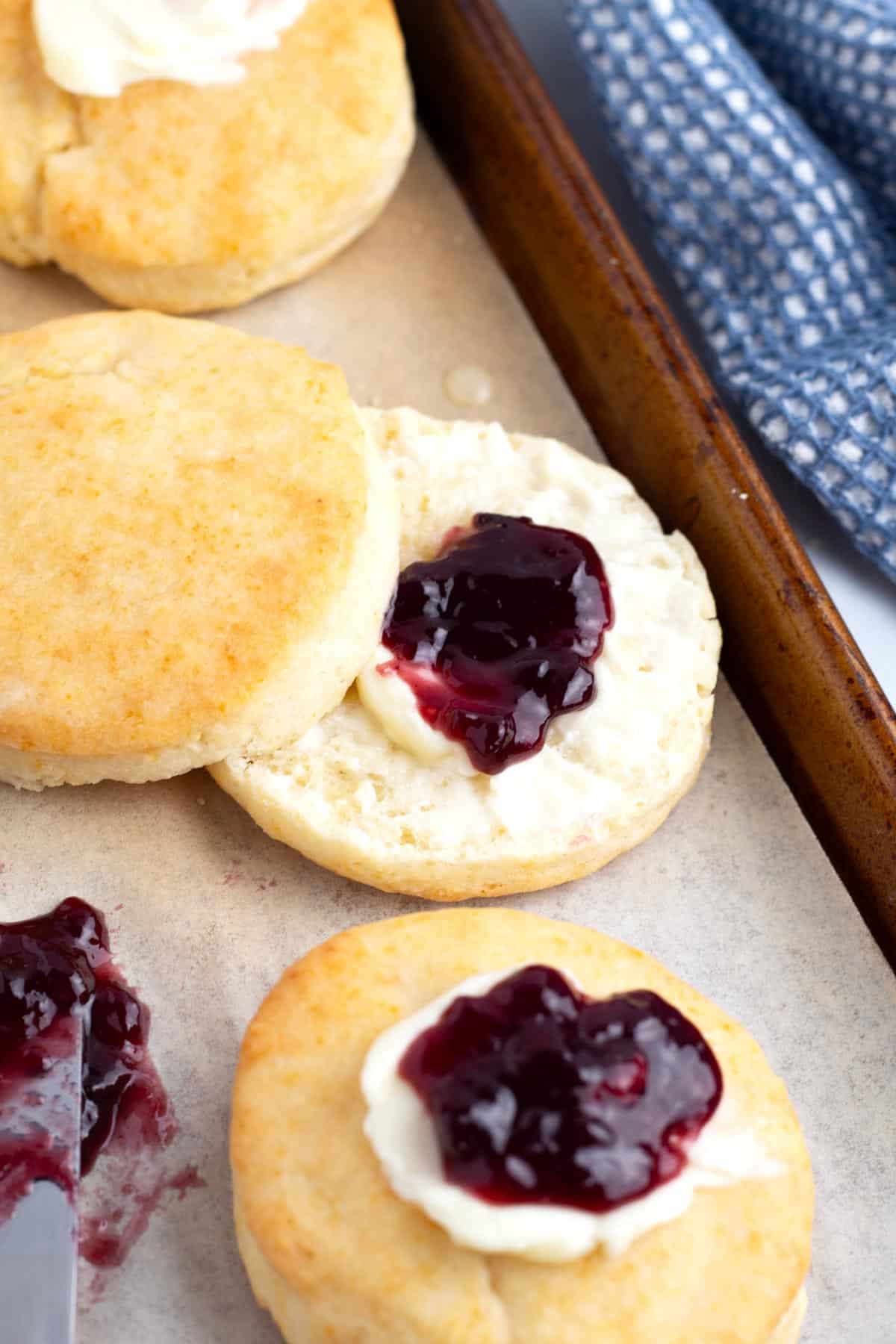Biscuit cut in half and slathered with butter and fruit spread.