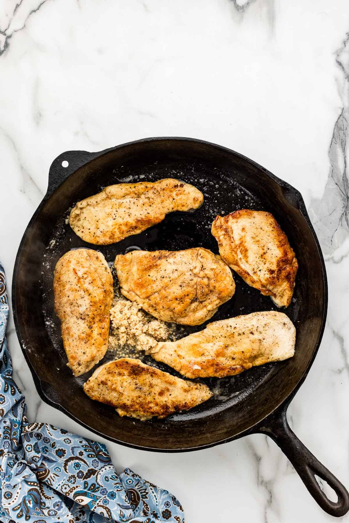 Cooking minced garlic in pan to mellow flavor and caramelize it.