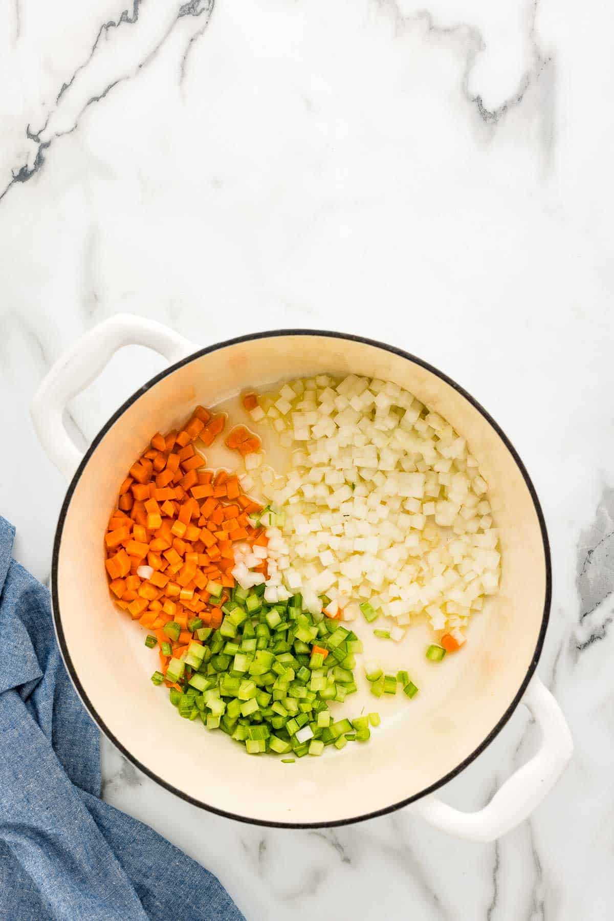 Cooking onions, celery, and carrots - also known as mirepoix - before adding in other ingredients to the soup pot.