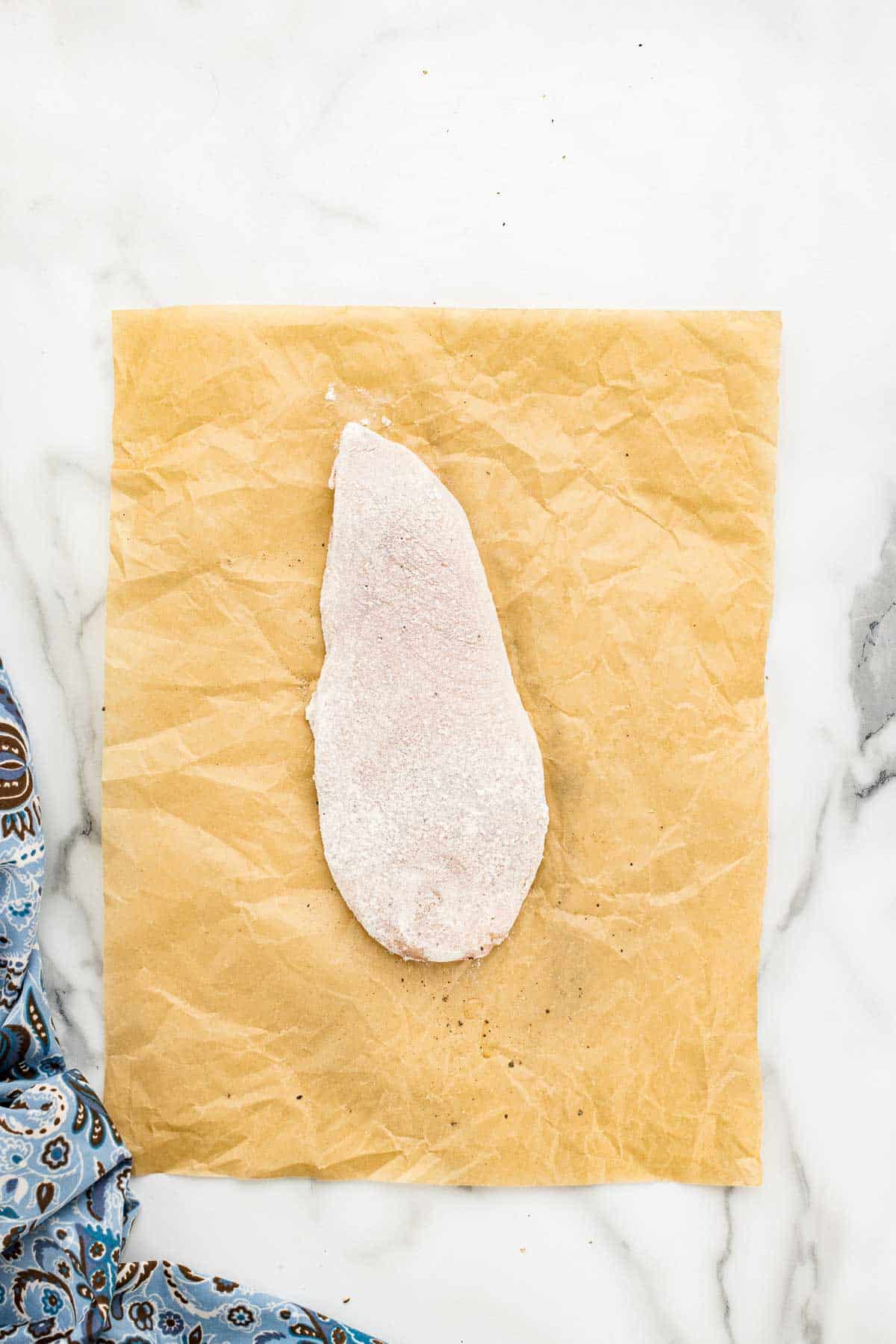 Chicken breast coated in very light layer of flour.