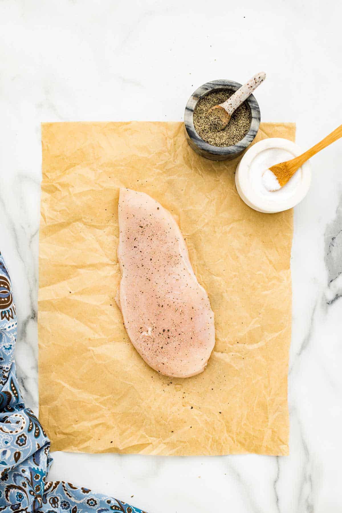 Salt and pepper on chicken breasts before coating in flour.