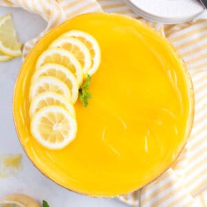 Lemon slices layered over the top of left side of cheesecake.