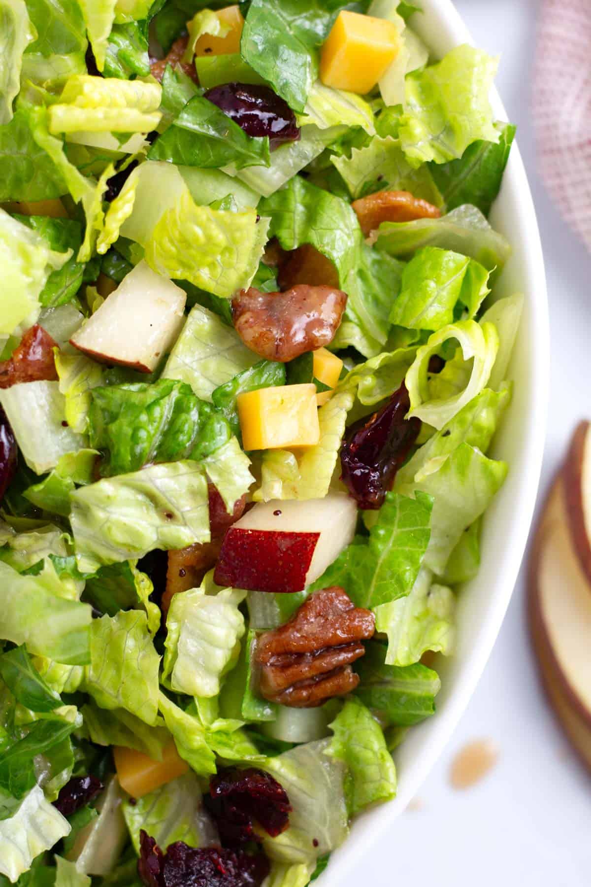 Fall inspired chopped salad in bowl with sweet balsamic dressing.