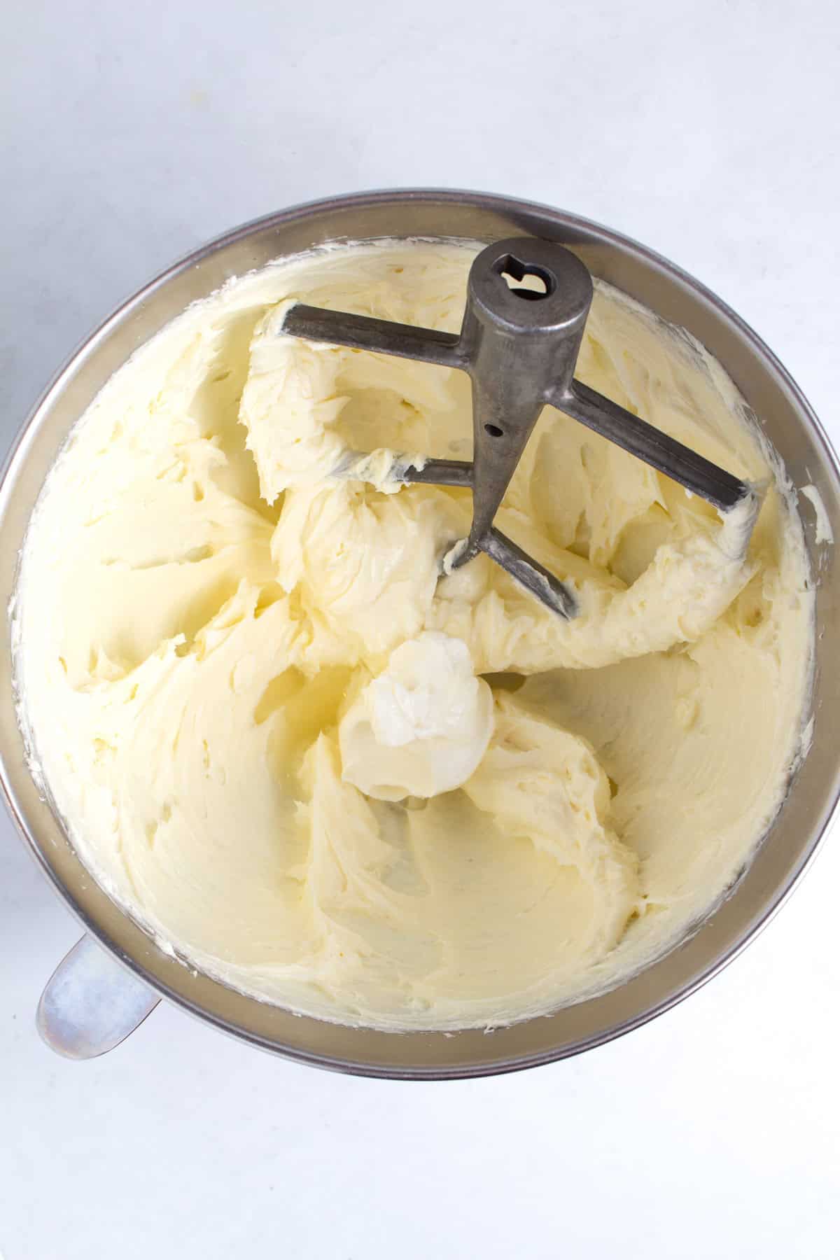Mixing sour cream and lemon into cream cheese filling.