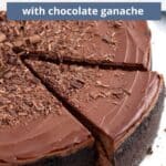 A single slice of ganached cheeecake slightly removed from the platter with blue text overlaid at the top of the image.