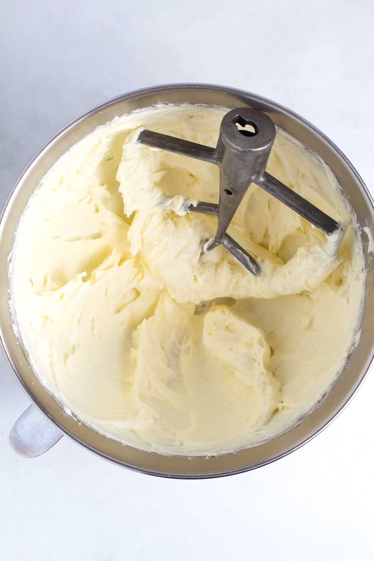 Whipped cream cheese and sugar in bowl of stand mixer.
