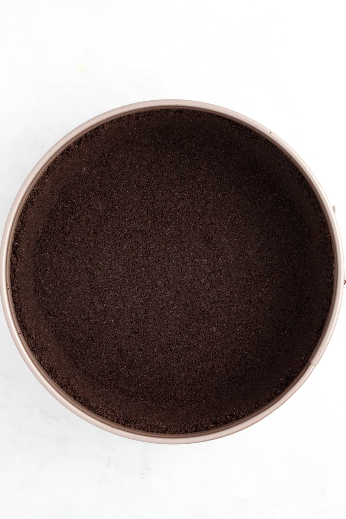 Oreo crust in a springform pan.