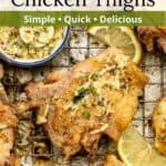 Juicy chicken thighs on a cooling rack with lemon and parmesan sauce in a small dish next to them with a graphic overlay.