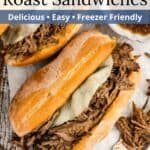 Two juicy sandwiches and a bowl of French dip on a piece of parchment paper with blue overlaid text.