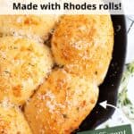 Garlic Rhodes rolls sprinkled with parmesan in a cast iron pan with green text overlaid.