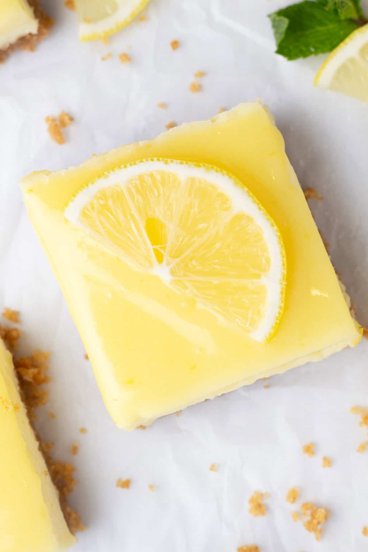 A fresh lemon bar topped with a light yellow glaze.