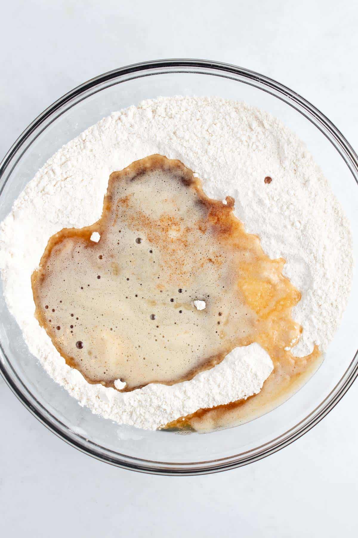 A glass bowl of flour and browned butter.