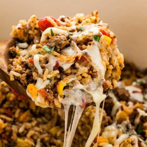 Cheese stringing from a spoonful of Mexican stuffed pepper casserole.