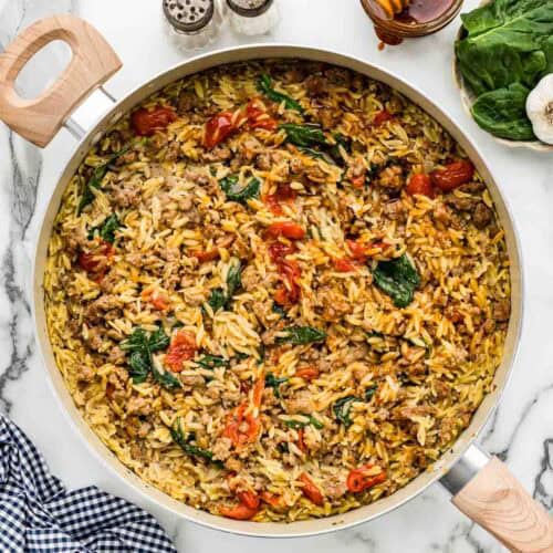 Orzo pasta with hot honey in a large cooking pan.