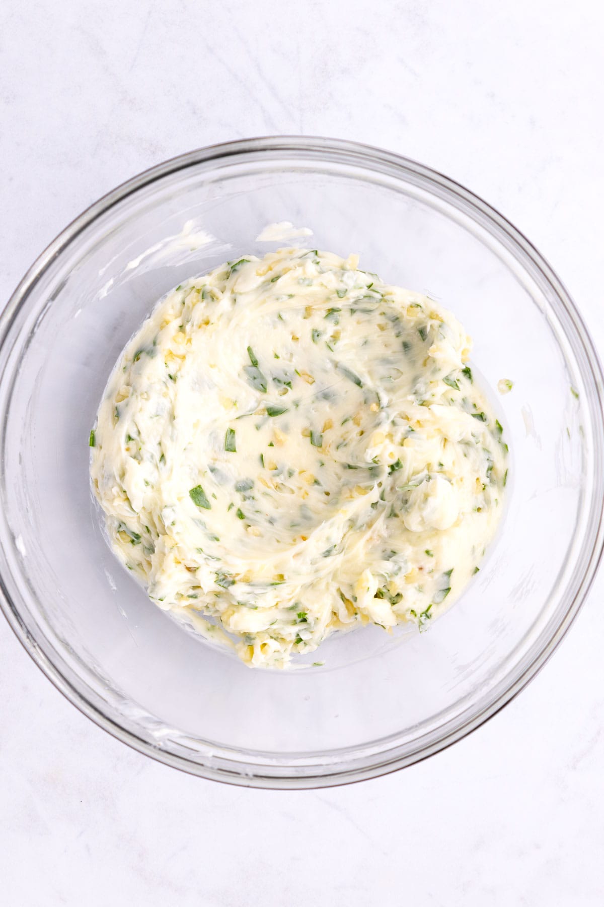 Garlic bread spread mixed in a glass bowl.