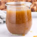 Closeup of a jar full of ham glaze.