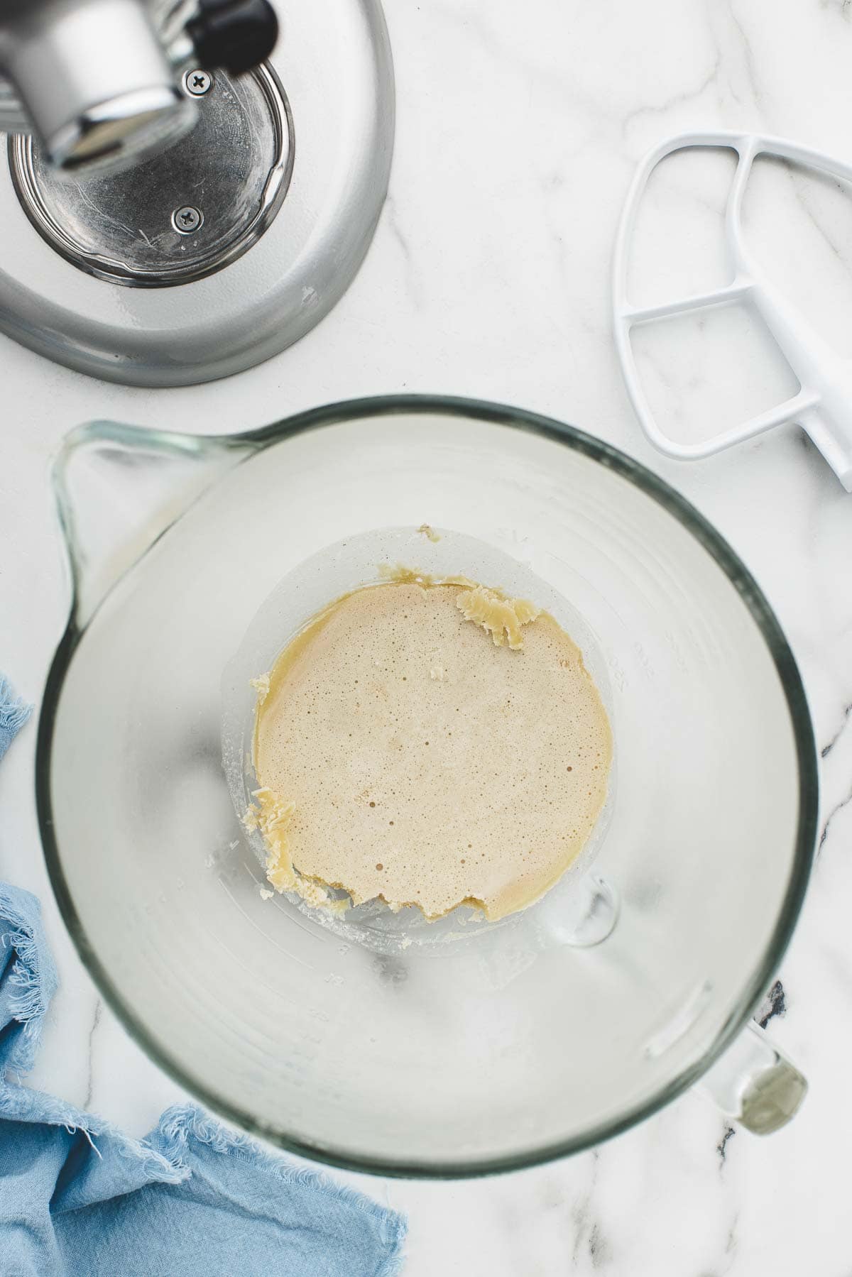 A glass bowl with chilled brown butter at the bottom.