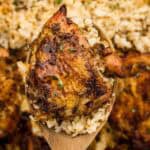 Chicken and rice on a wooden cooking spoon.