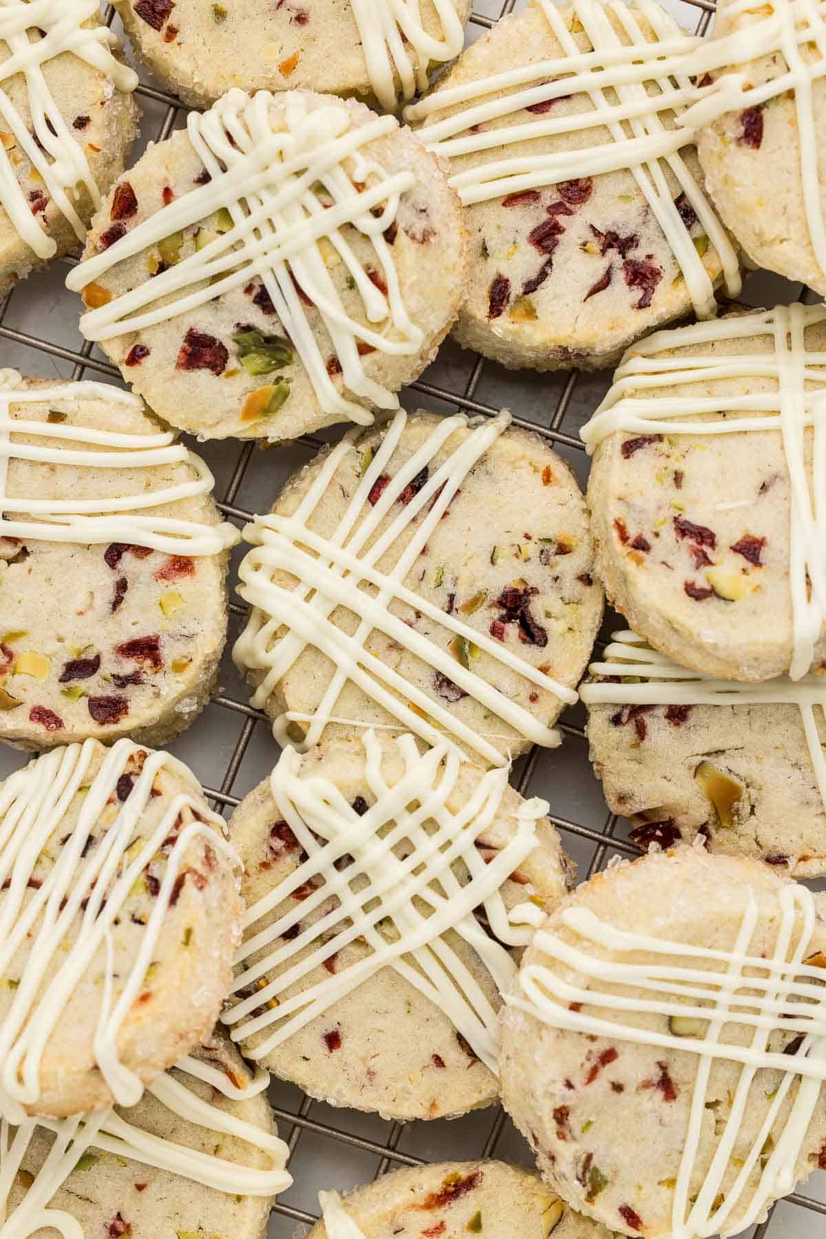 A pile of cranberry pistachio cookies on a wire rack.