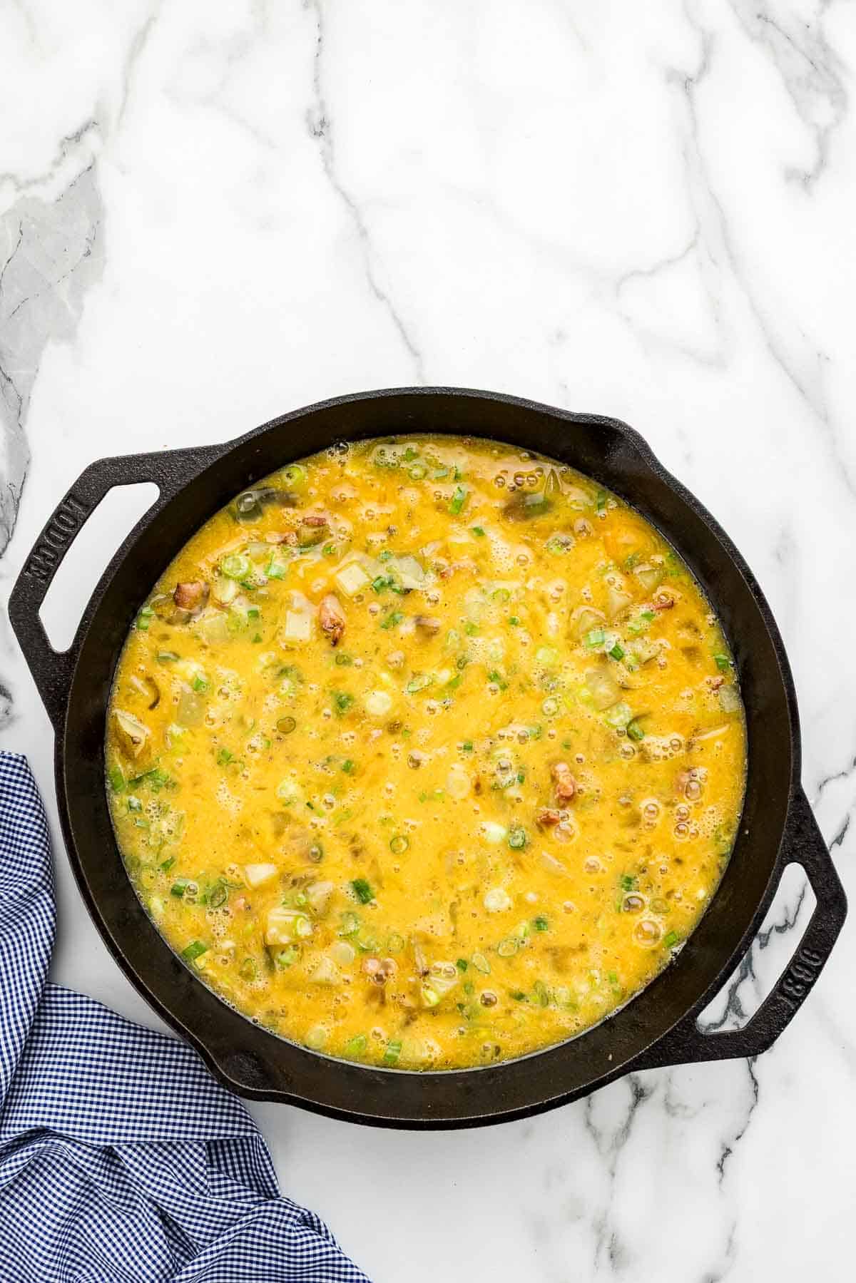 Uncooked breakfast bake in a skillet.