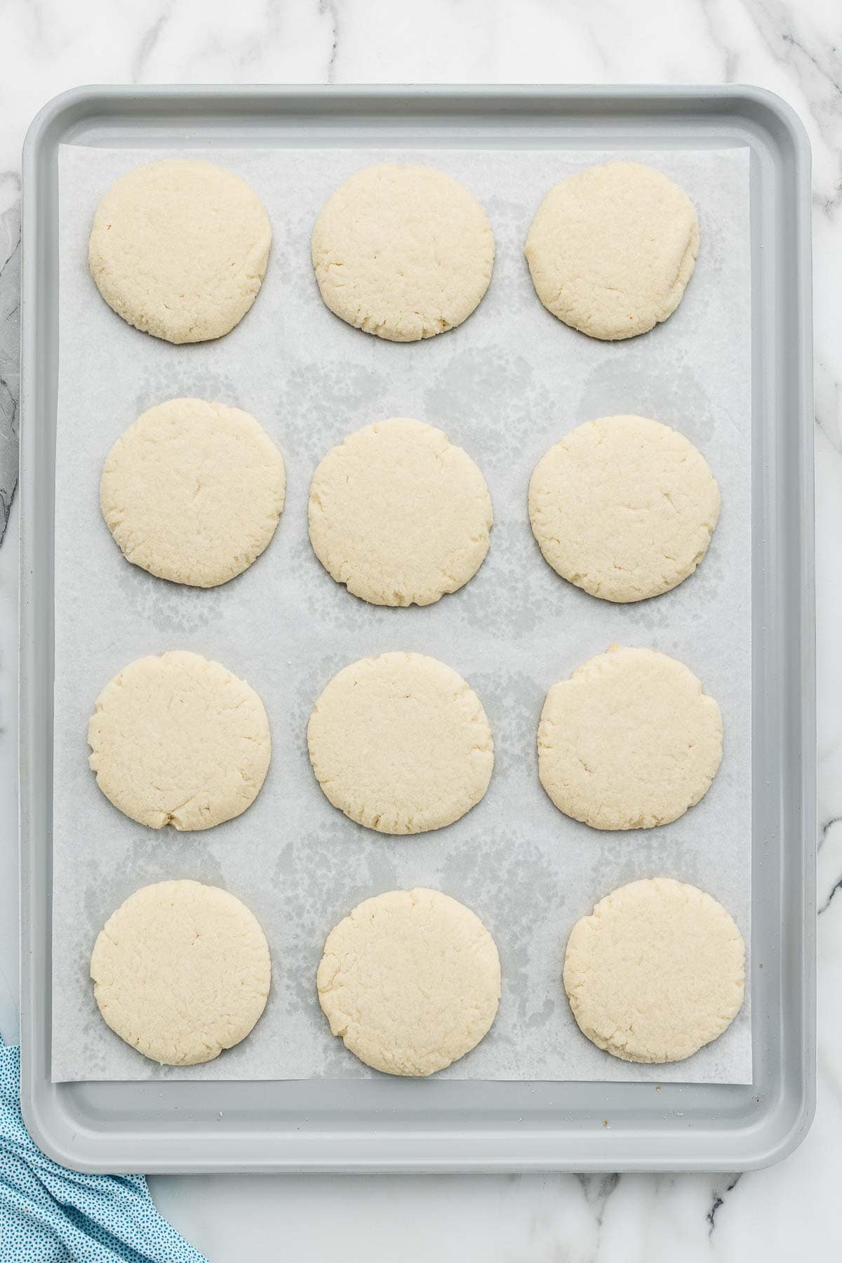 Baked sugar cookies on a sheet pan.