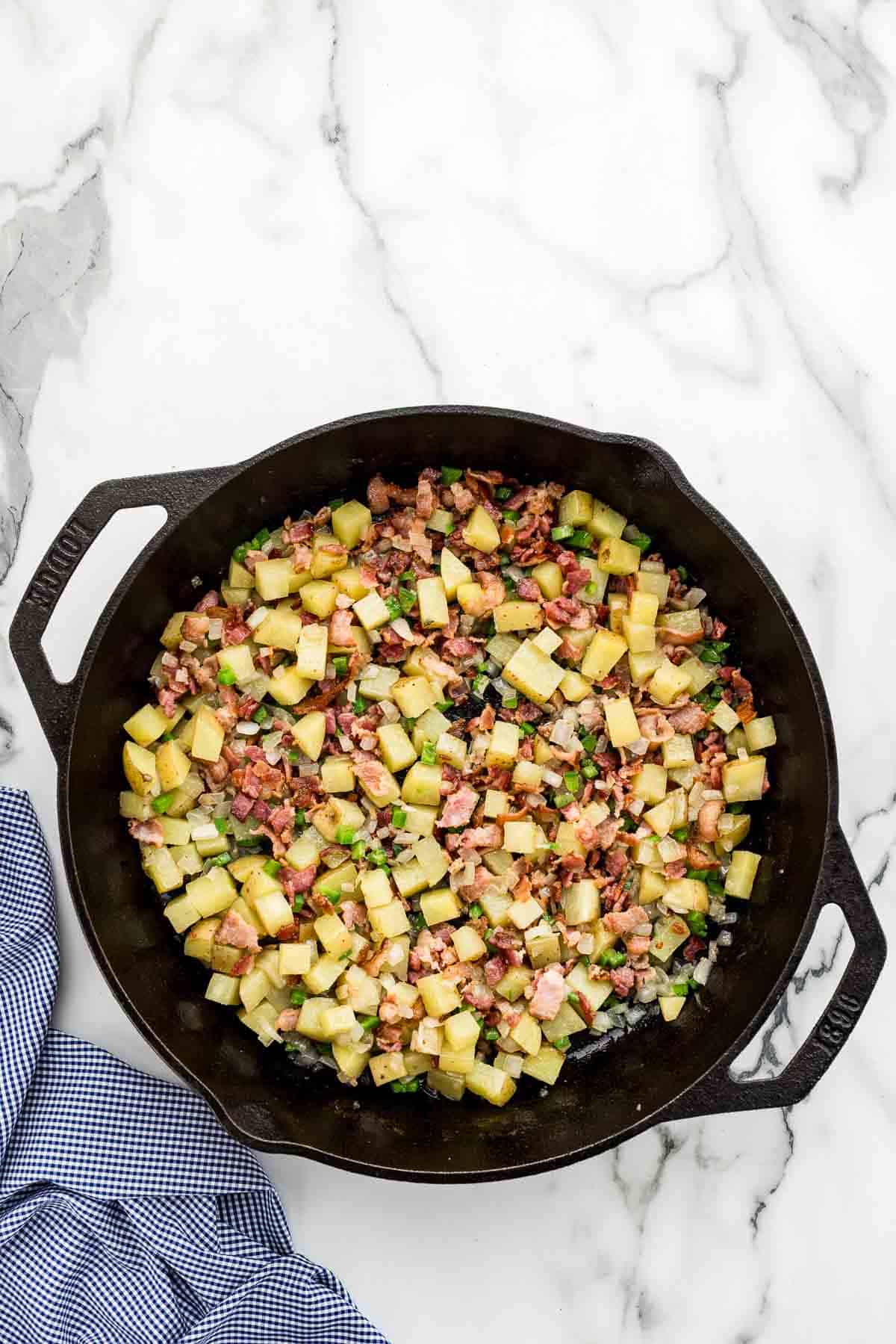 A pan of chopped veggies and bacon.