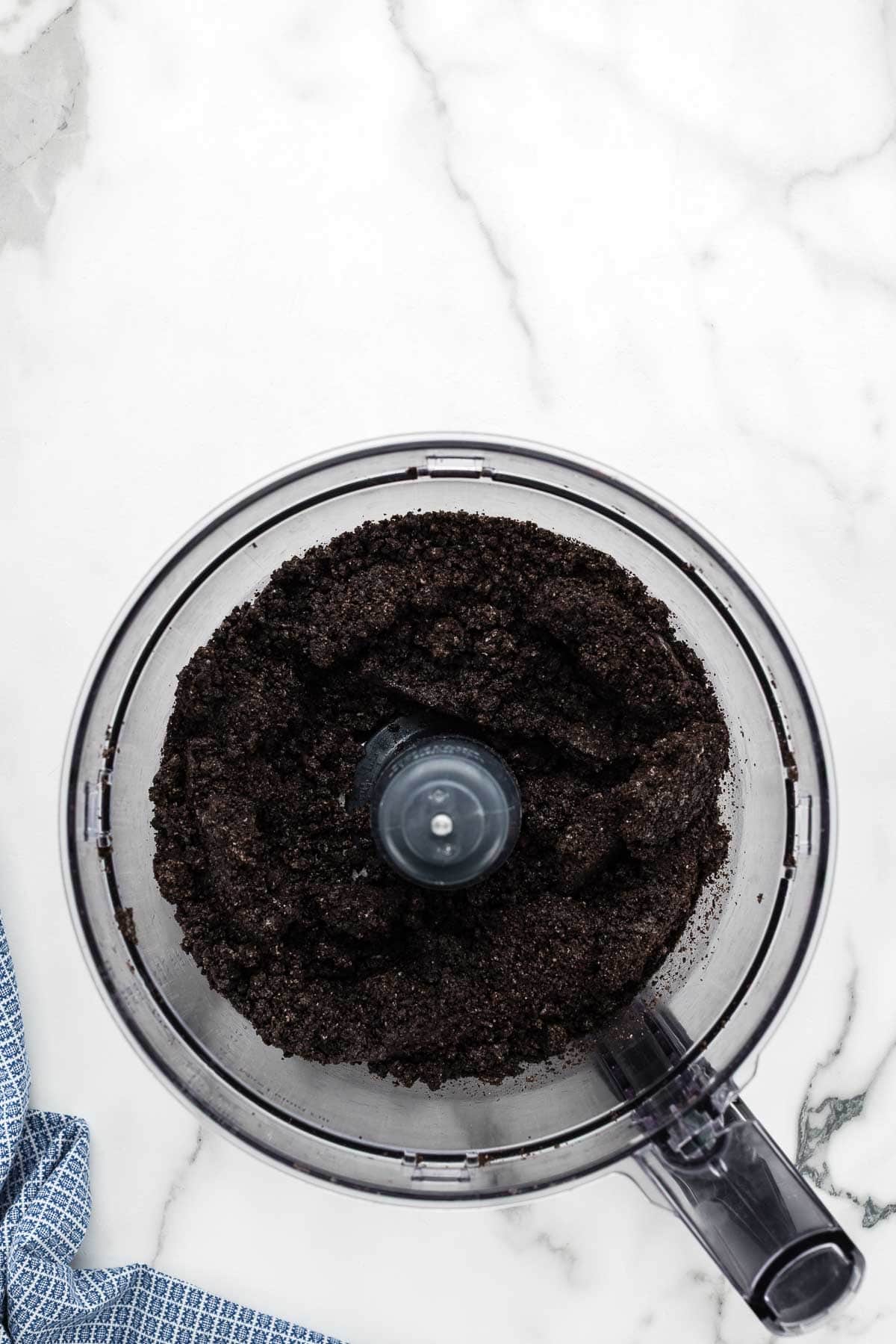 A food processor full of ground oreos.