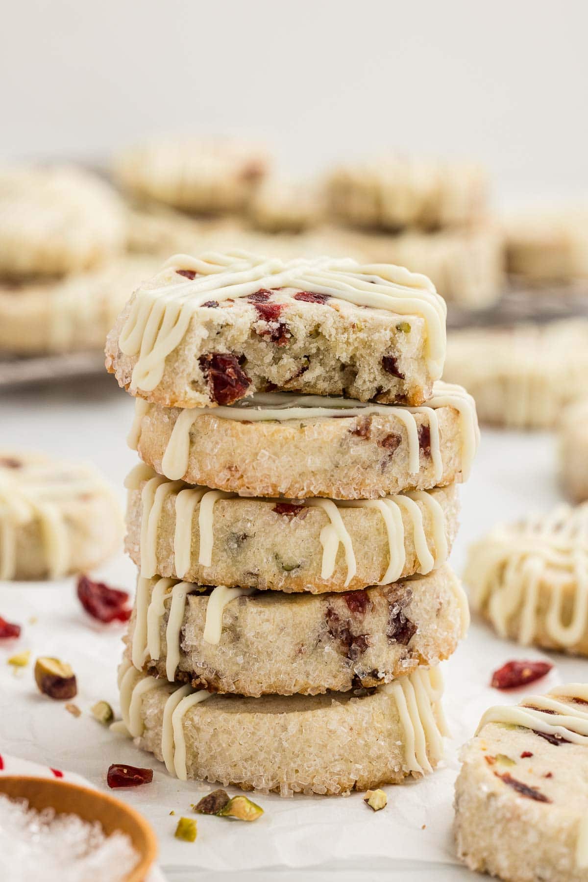 Cranberry pistachio cookies stacked in a pillar.